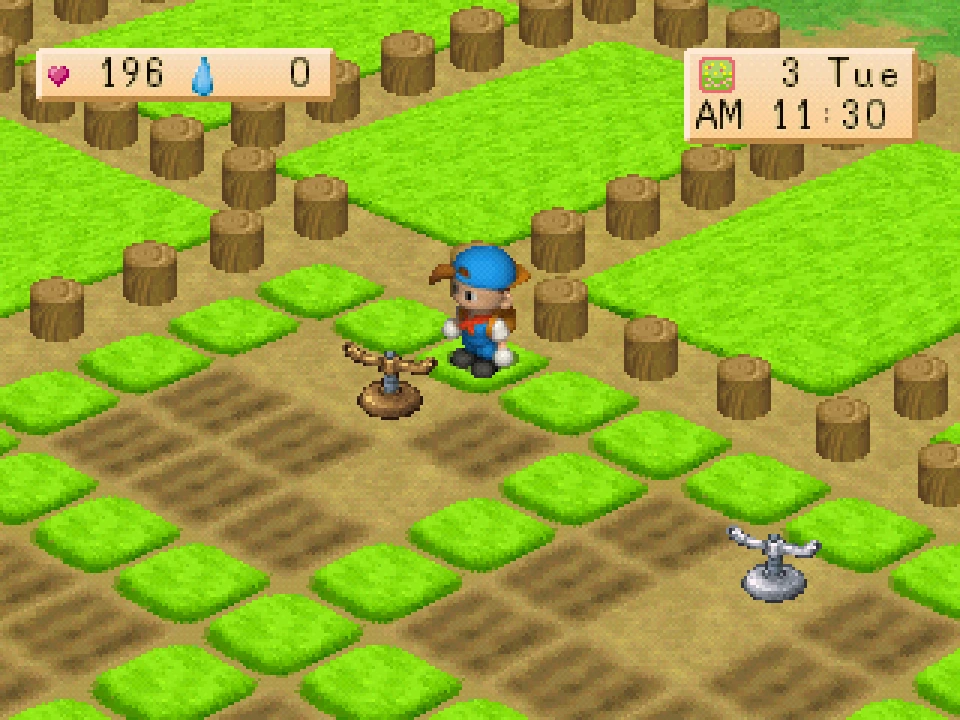 A bronze-coloured and a silver-coloured sprinkler placed on the farm field.